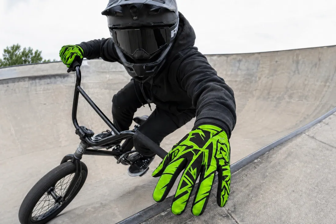 BMX rider in a skatepark bowl wearing Gloves Galore BMX gloves