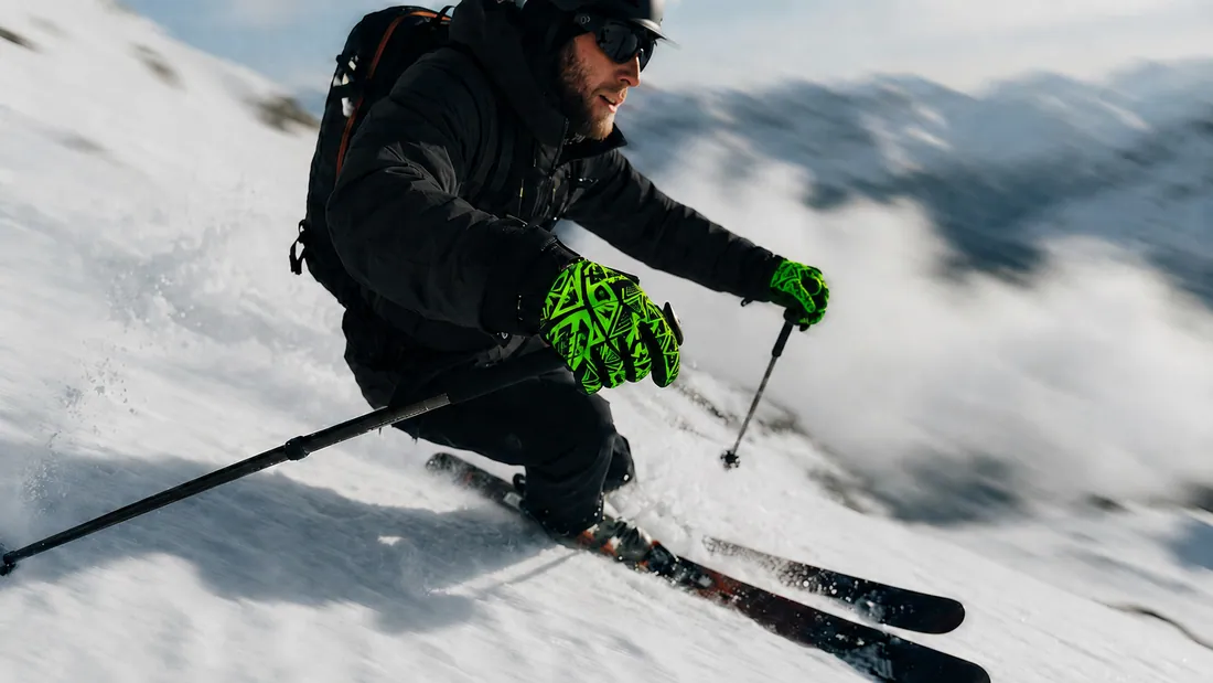 Skier on a snowy slope wearing Gloves Galore ski gloves